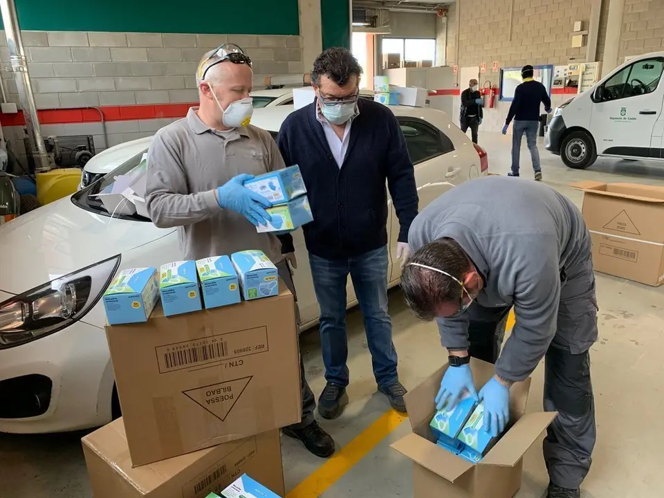 Treballadors de la Diputaci&oacute; de Lleida preparant els lots amb mascaretes i ulleres de protecci&oacute; per enviar-les als ajuntaments de la demarcaci&oacute;, el 14 d'abril del 2020. (Horitzontal)