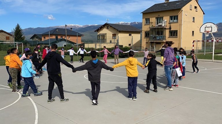 Pla obert d'un grup d'alumnes de l'escola Alfons I de Puigcerdà duent a terme una activitat de les jornades emocionals a l'exterior. Imatge del 13 de maig de 2021 (Horitzontal).