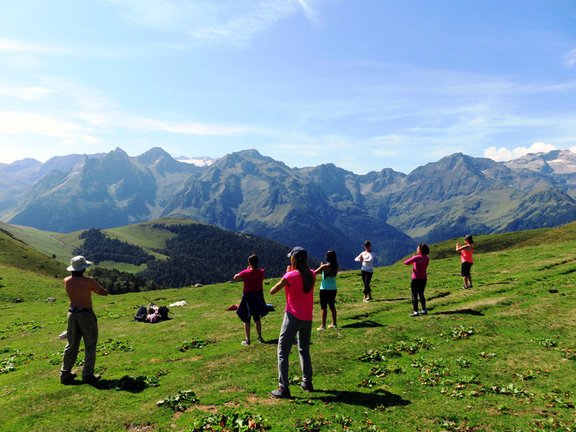 Un grup de persones practicant ioga en plena natura. (horitzontal)