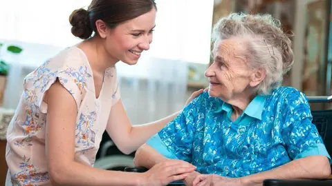 Senior woman with her caregiver at home