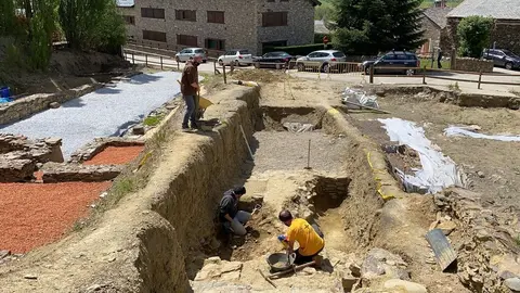 Pla obert on es veu una part del f&ograve;rum rom&agrave; 'Iulia Libica' excavada i un equip d'arque&ograve;legs treballant en aquest jaciment situat a Ll&iacute;via (Cerdanya). Imatge del 20 de maig de 2021. (Horitzontal).