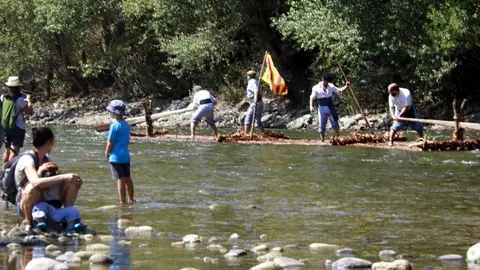 Pla obert d'un rai navegant pel riu Segre i d'espectadors mirant-ho en la 32a baixada de raiers de Coll de Narg&oacute;, el 21 d'agost de 2021. (Horitzontal)