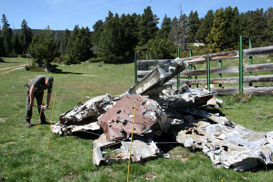 Pla general del cap dels Agents Rurals de la Cerdanya, Josep Pujol, fent un perímetre al voltant de la ferralla d'una avioneta que va aterrar