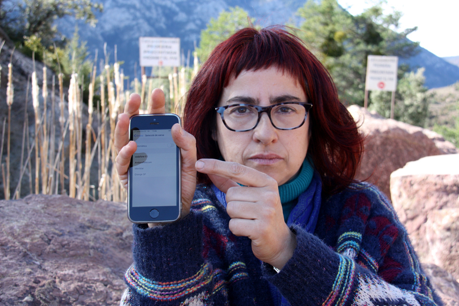 Pla mitjà de l'Anna Gonzalez, a qui li han facturat 430 euros de 'roaming', mostrant com la xarxa andorrana apareix amb cobertura en una antiga pedrera situada a la carretera que va cap al nucli de la Guàrdia d'Ares, el 27 de febrer de 2020 (Horitzontal).