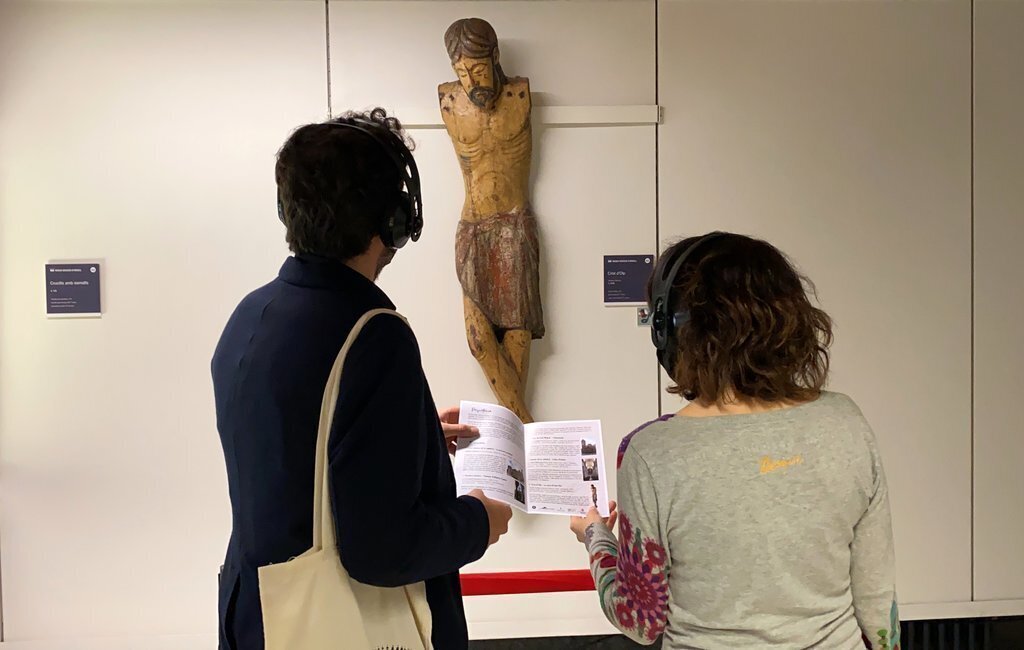 Pla mitjà de la delegada de Patrimoni Cultural del Bisbat d'Urgell, Clara Arbués, i el tècnic en cultura i patrimoni, Jordi Quer, mirant una de les obres del Museu Diocesà d'Urgell de l'itinerari 'Emocionari literari', el 18 de maig de 2021. (Horitzontal)