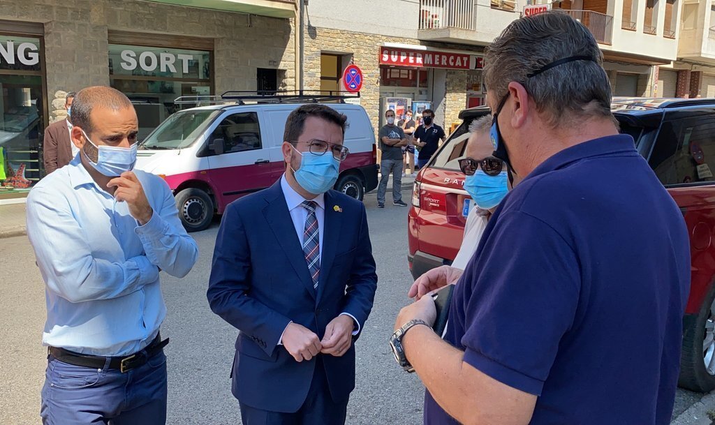 Pla mitjà del president de la Generalitat, Pere Aragonès, i l'alcalde de Sort, Baldo Farré, parlant amb el president de l'Associació d'Empreses d'Esports d'Aventura del Pallars Sobirà, Florido Dolcet. Imatge del 26 d'agost de 2021. (Horitzontal)